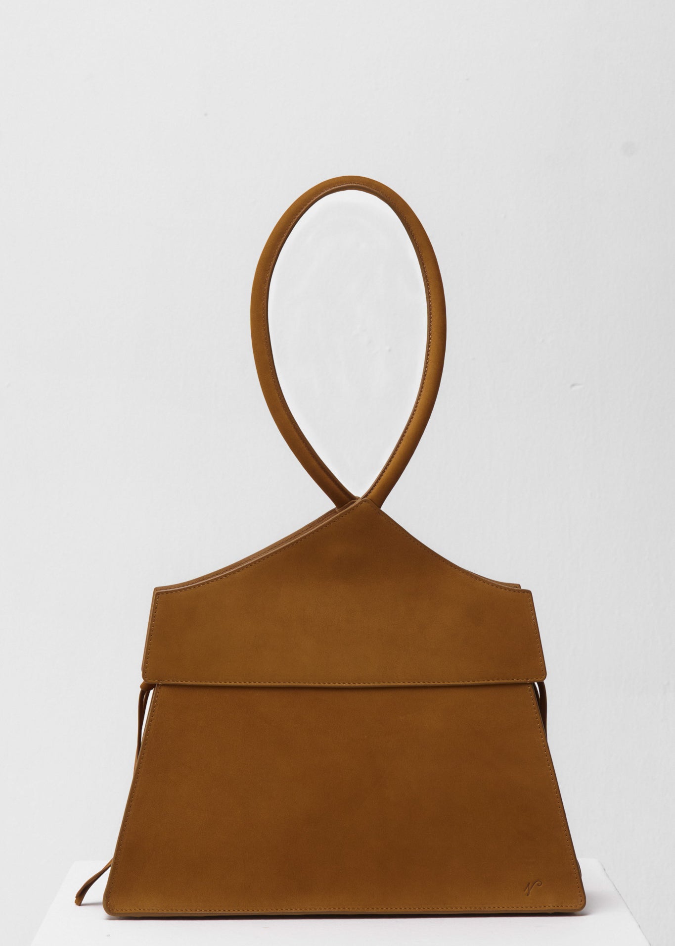 Brown suede handbag on a white background