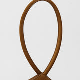 Close-up of a brown suede handbag with a rope handle on a white background