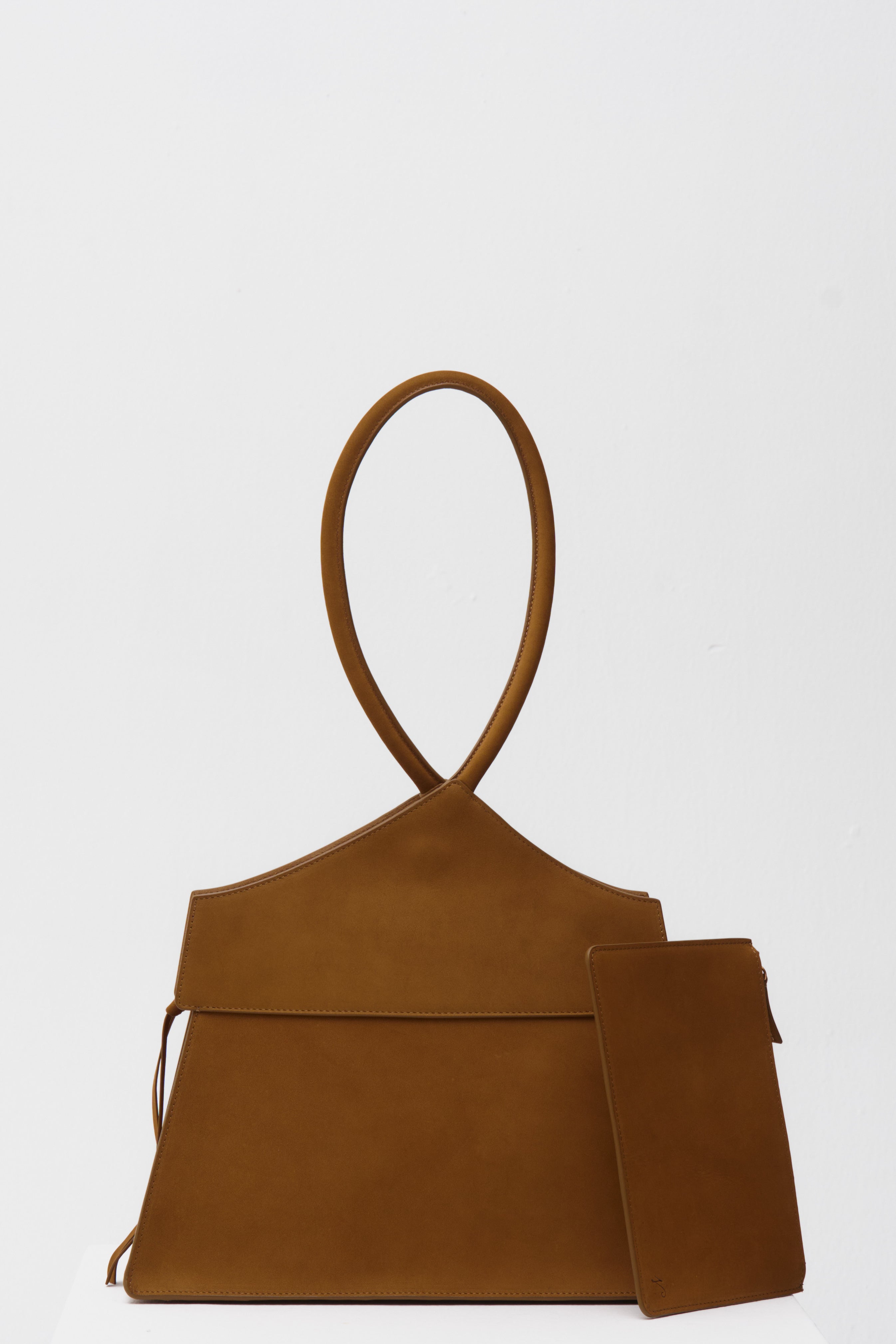 Brown handbag with matching pouch on a white background
