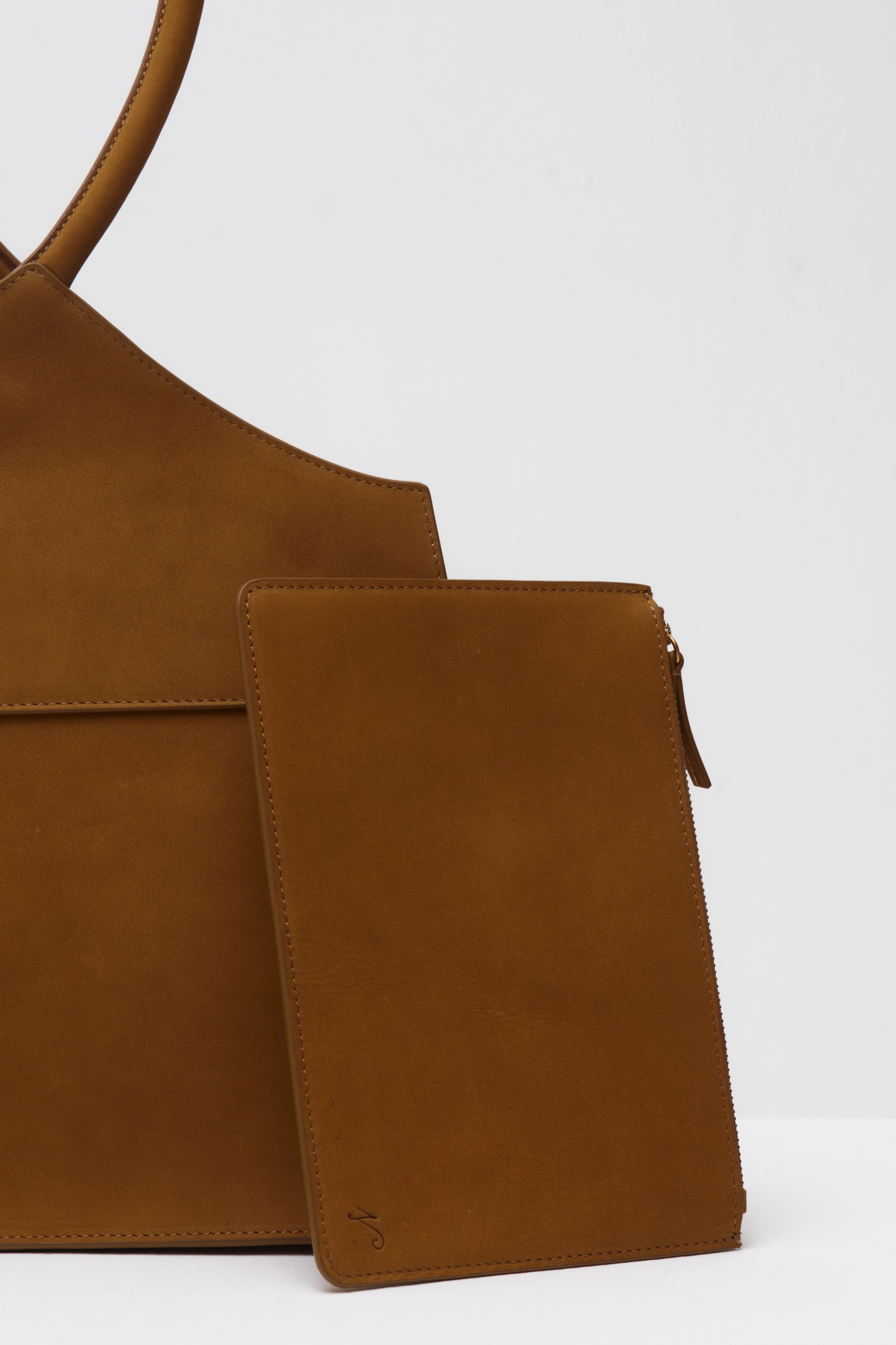 Brown suede bag on a white background
