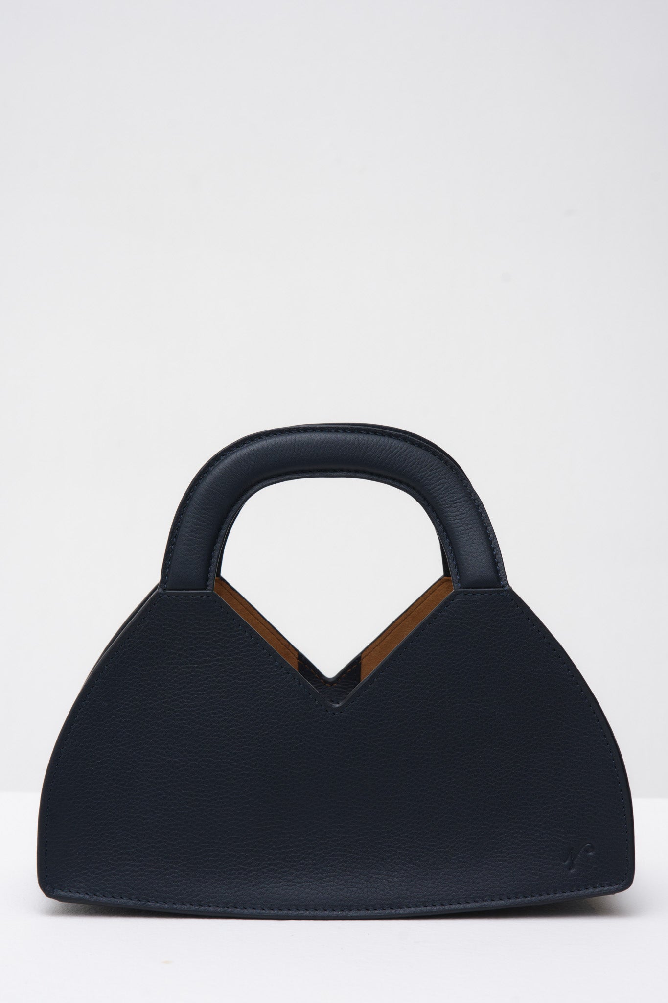 Navy blue handbag with a structured handle on a white background