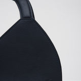 Navy blue handbag with a structured handle on a white background