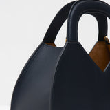 Navy blue handbag with a brown interior on a white background