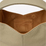 Close-up of a pastel green leather handbag with a brown interior pocket on a white background